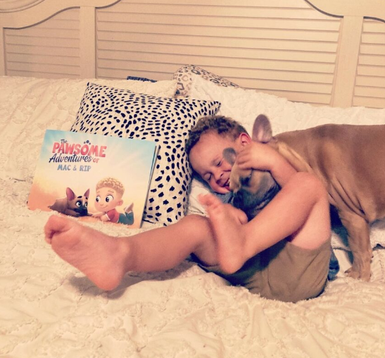 A little boy and his dog with a personalized book for pets and kids from Hooray Heroes.