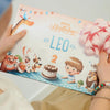 Girl holding the coolest gift for birthday which is a unique storybook for a child's birthday.