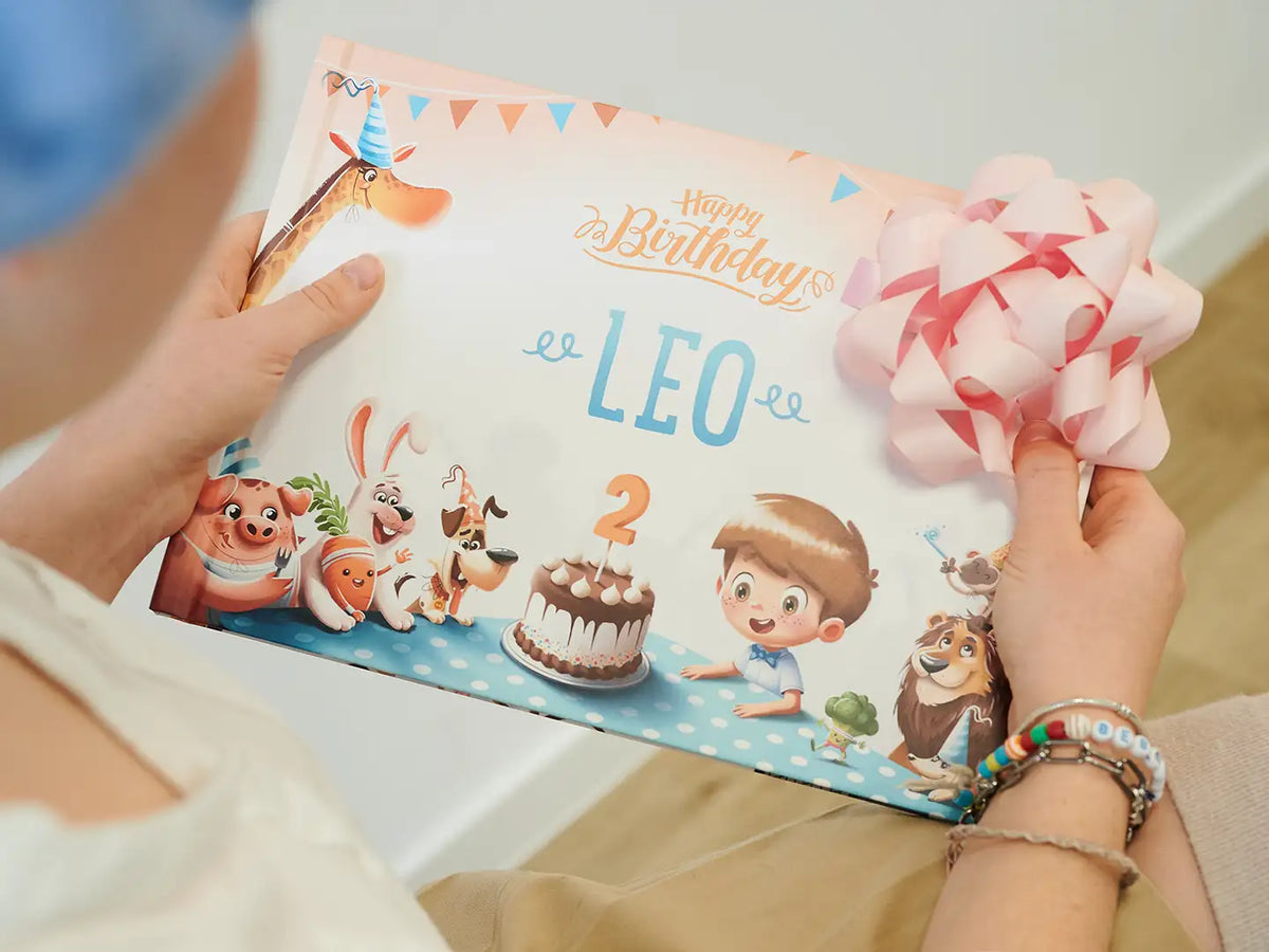 Girl holding the coolest gift for birthday which is a unique storybook for a child's birthday.