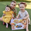 A little trio of brothers and sisters gathered thanks to their personalized story book from Hooray Heroes.