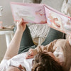 Girlfriend and boyfriend lying on the floor thinking what great DIY book gift they got for their anniversary.