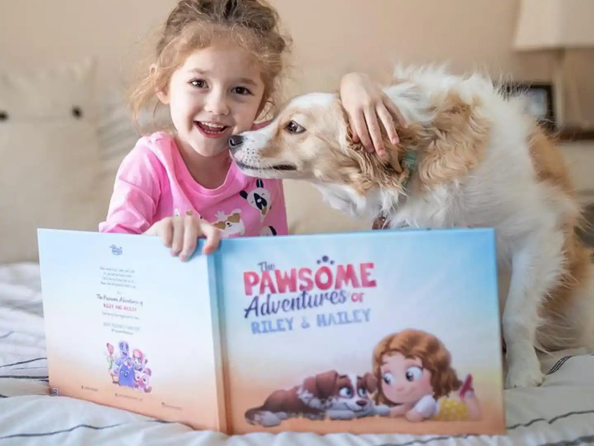 Girl lovingly holding her pet dog and being happy because she received a personalized book for pets as a gift.