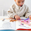 Boy with a cap is pointing to a fun colorful illustration from his customized nursery song book.