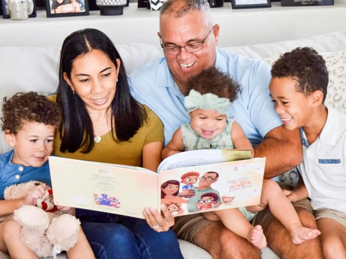 A family of grandparents and grandkids reading their best personalized book for granny and grandpa.