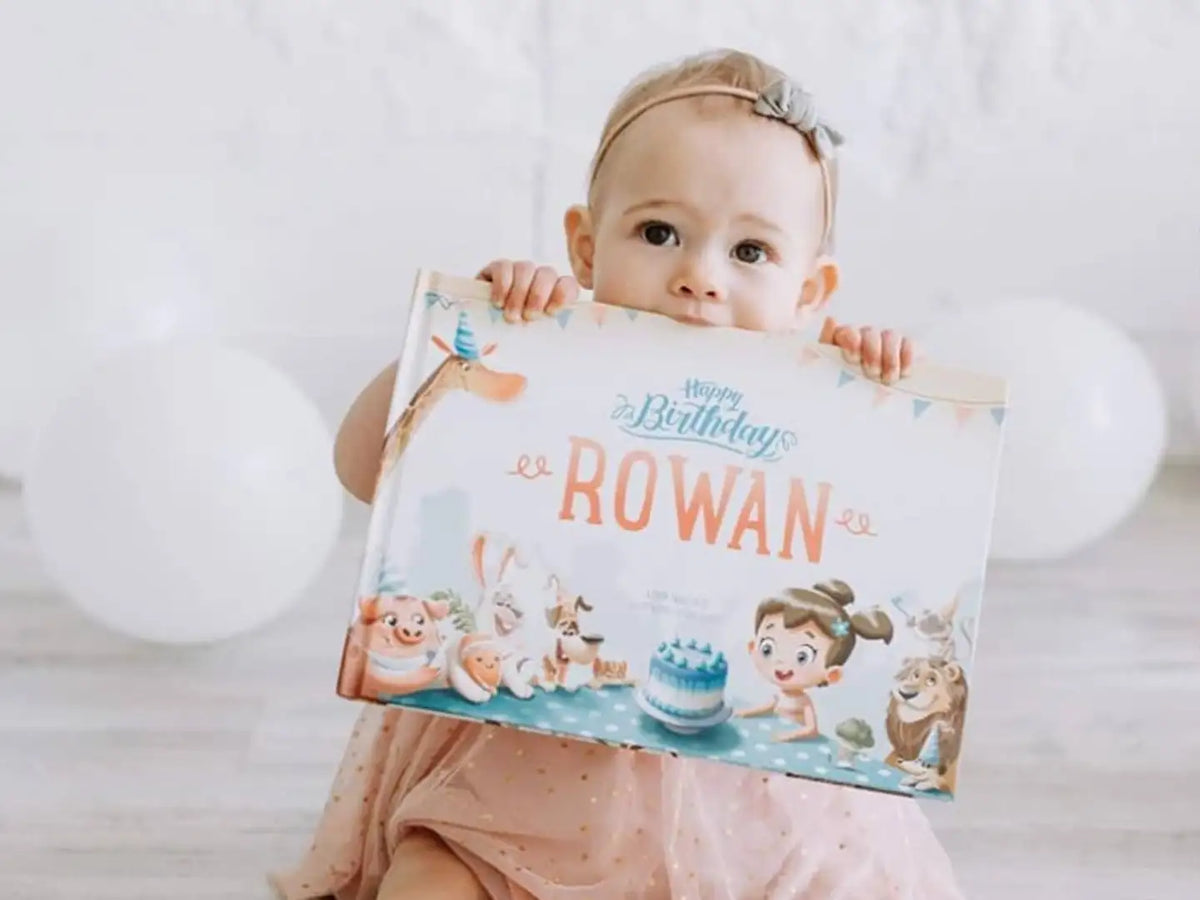 Little girl and her birthday book which makes your little one's special day even more memorable with custom birthday stories.