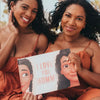 Beautiful mom and her daughter are showing their Hooray Heroes' book with personalized characters on the cover.