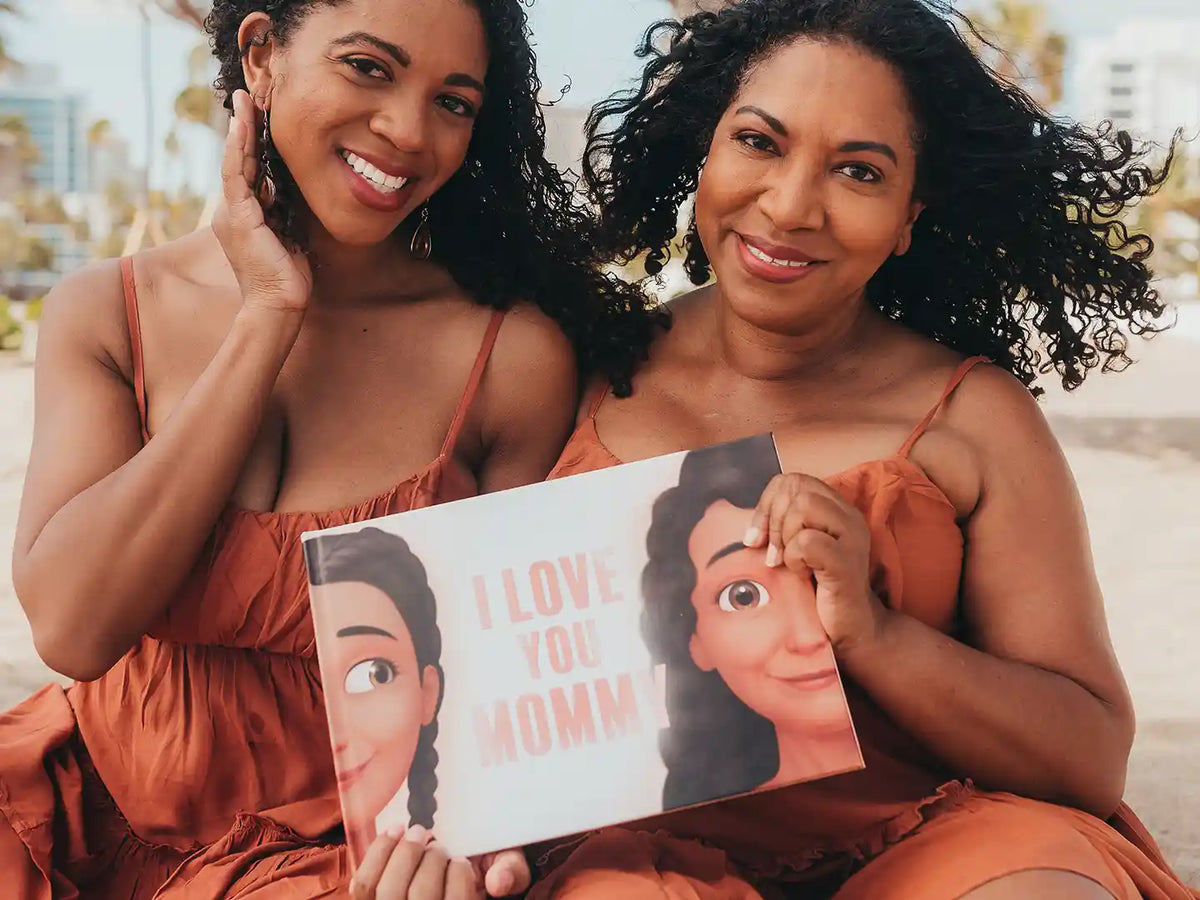 Beautiful mom and her daughter are showing their Hooray Heroes' book with personalized characters on the cover.