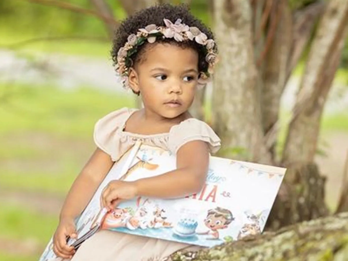 Girl is holding her custom birthday book she got for her birthday.