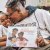 Dad giving a kiss to his daughter and holding their personalized book for families.