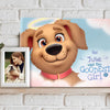 Personalized dog memorial canvas titled "Julie Was the Goodest Girl" by Hooray Heroes displayed on a shelf with a framed photo of the owner and pet.