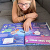A girl is learning about space from her new personalized encyclopedia from Hooray Heroes .