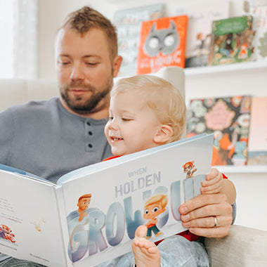 Daddy and baby reading their very own custom book all about what he or she may grow up to be.