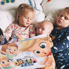 Three siblings enjoy their personalized adventure book for two or three children.