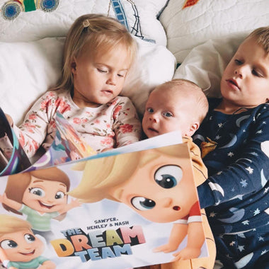 Three siblings enjoy their personalized adventure book for two or three children.
