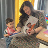 Mom reads the personalized book she got for Mother's Day from her husband and son.