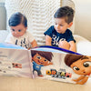 Brothers enjoy looking at the pictures in their one-of-a-kind treasure hunt book for two or three children. 