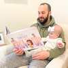 Dad reads from a Hooray Heroes custom book, the perfect gift for daddy.