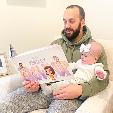 Dad reads from a Hooray Heroes custom book, the perfect gift for daddy.