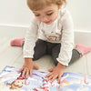 A child smiles at her new custom Xmas book for kids that she got as a Christmas gift.