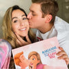 A man is kissing his girlfriend who just got her personalized love book for couples which is a great Valentine's Day gift.