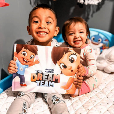 A brother and sister smile with their dream team adventure book for two or three friends, siblings or cousins.