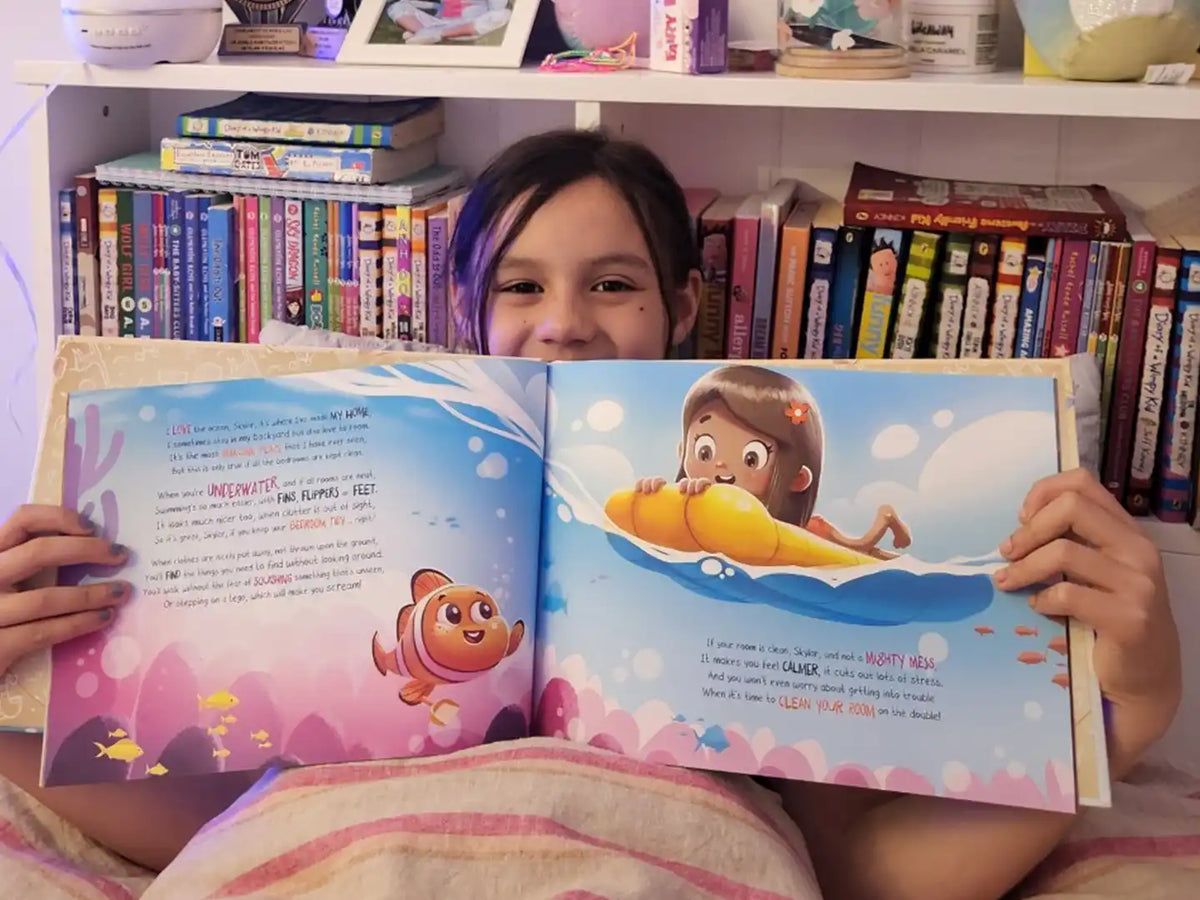 An eight-year-old girl is holding her personalized birthday book.
