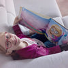 An 8-year-old girl is reading her personalized birthday book.
