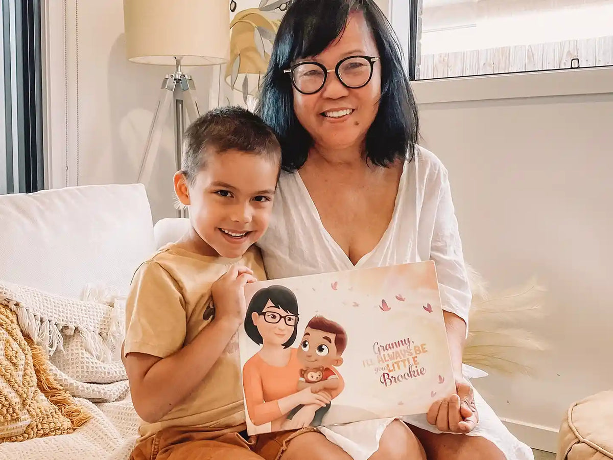 A smiling boy and his grandma with their new personalized book with them as the main characters.