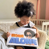 A little girl is looking at her new personalized home alone book.