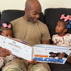 A dad is reading a personalized book about being home alone to his kids.