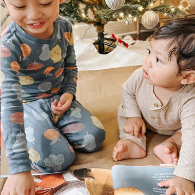 Brothers flip through their unique, DIY Christmas book together, perfect for siblings. 