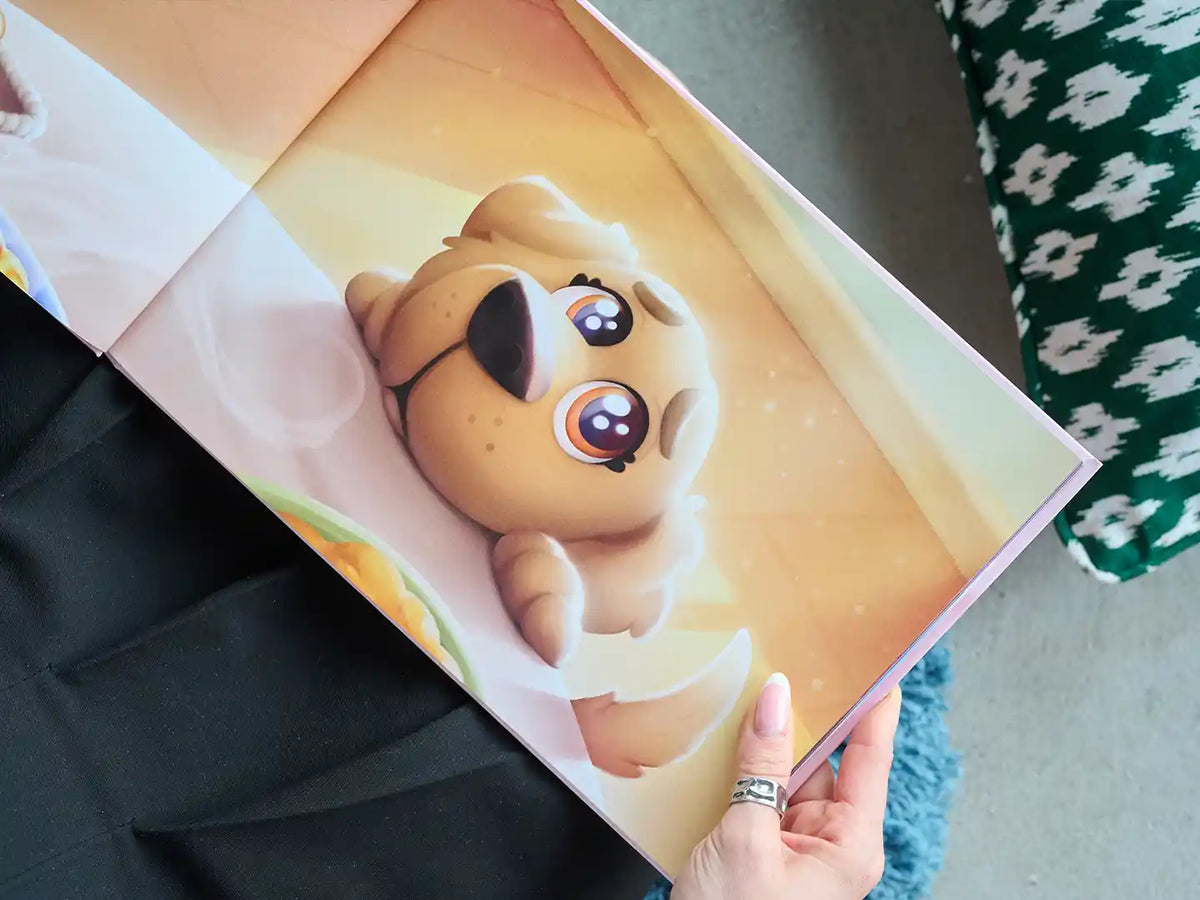 Close-up of an illustrated page from a personalized dog book, featuring an adorable cartoon dog with big, expressive eyes lying on a cozy, golden background.