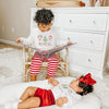 A boy reads his little sister a custom Xmas book just for the two of them, an amazing Christmas gift for siblings. 