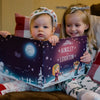 Siblings are having fun browsing through their fun personalized festive book about Christmas.