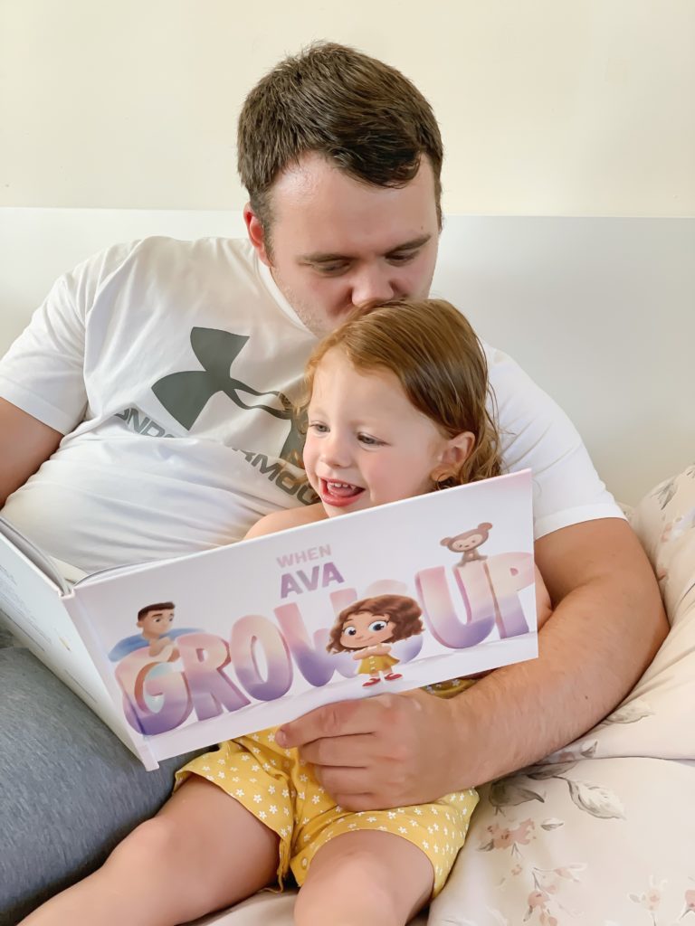 Daddy and daughter reading together Hooray Heroes' personalized Grows Up Book