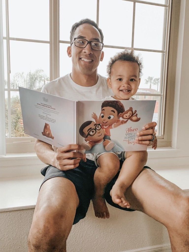 Daddy and his son with a personalized book by Hooray Heroes.