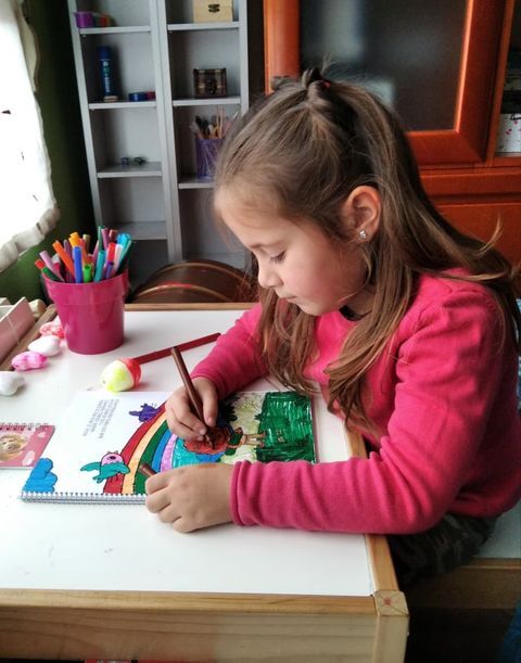 A little girl drawing and coloring her milestones  coloring book from Hooray Heroes.