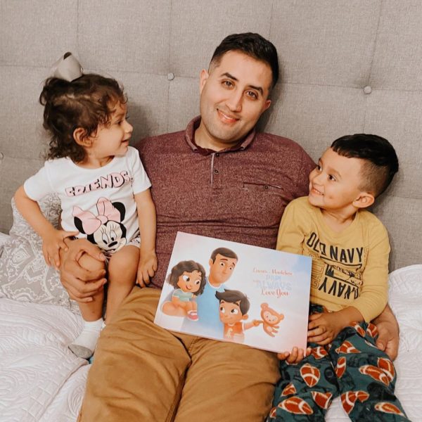 A daddy and his two kids reading a personalized book for daddies by Hooray Heroes.