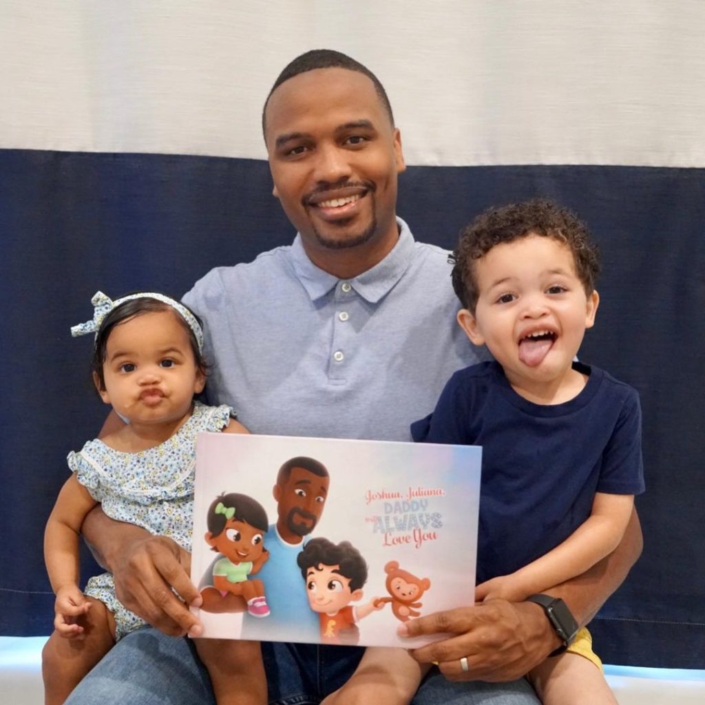Dad with his two kids and a personalized book for siblings