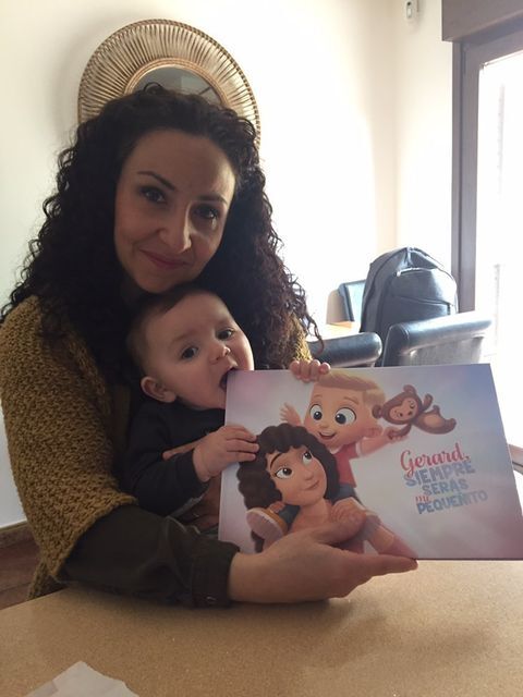 A mom and her son with a personalized book for the two of them.