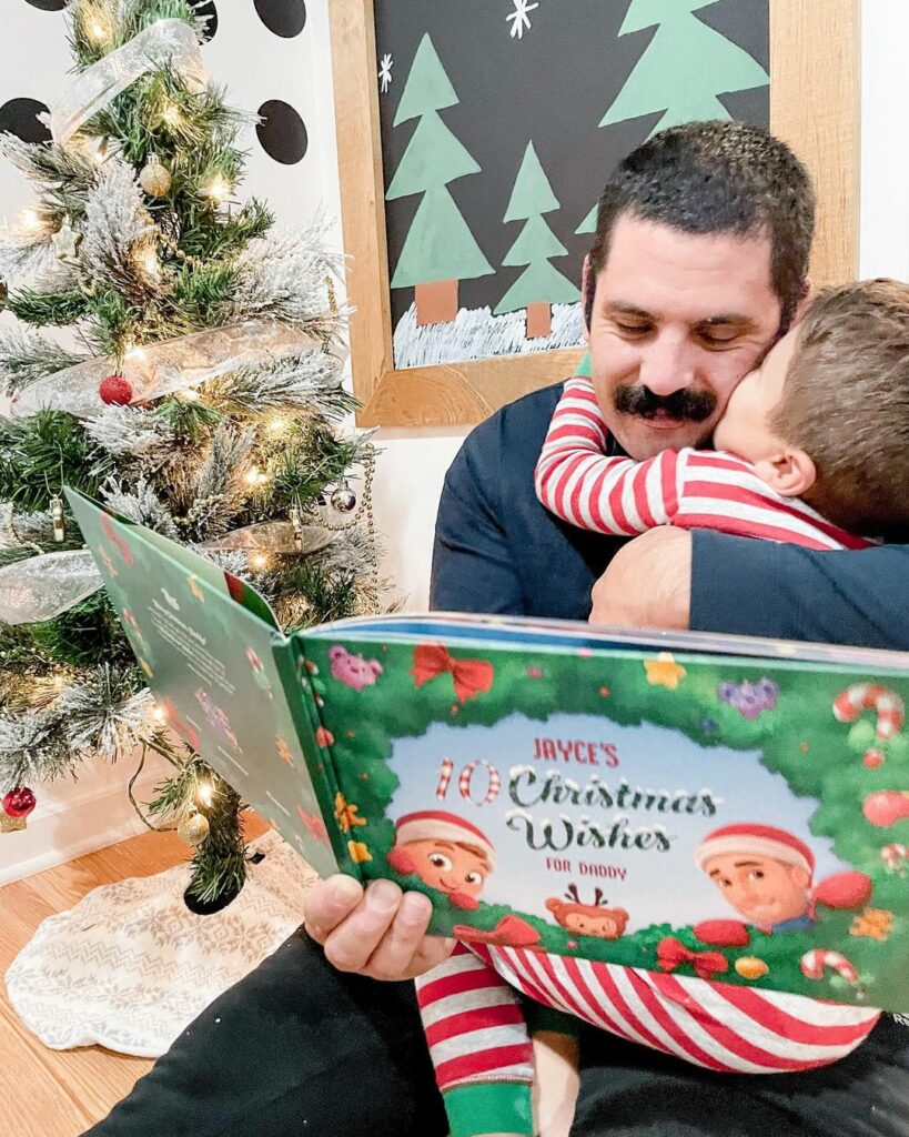 A father and child reading the personalized Christmas book from Hooray Heroes.