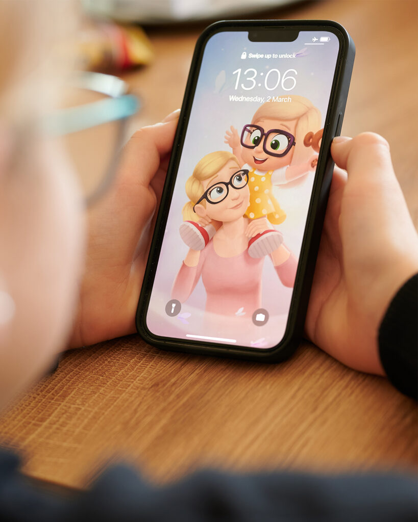 A person holding a phone with a personalized wallpaper for moms and their kids.