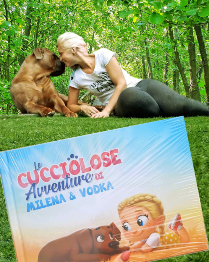A woman cuddles her dog outside alongside a personalized book for pets,.