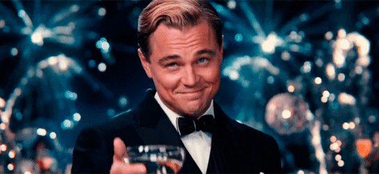 Leonardo Dicaprio in the movie The Great Gatsby toasting with a glass of champagne.