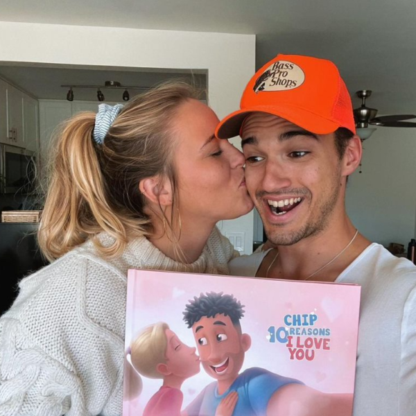 A girlfriend giving her boyfriend a personalized book for his birthday.