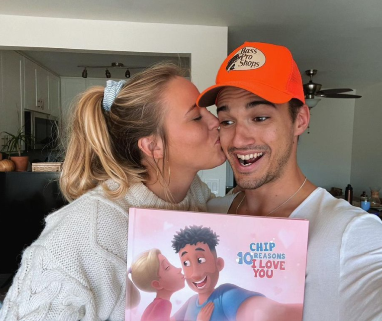 A girlfriend giving her boyfriend a personalized book for his birthday.