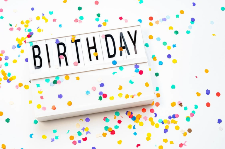 A letterboard with the word "birthday" on it and confetti.