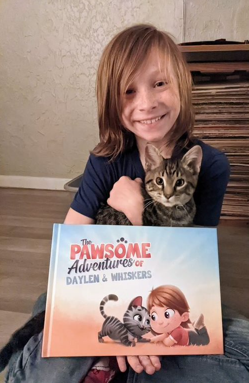A boy and his cat with a personalized birthday gift.