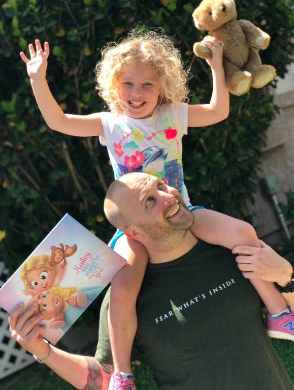 A dad and his little girl happy about the birthday gift.