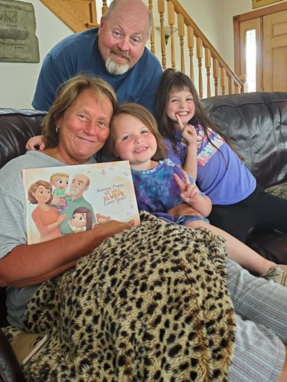 Grandparents and two granddaughters with a personalized book for grandparents by Hooray Heroes.